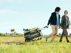 man dragging wheeled cooler on the plain