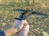 hands aiming crossbow pistol in the field