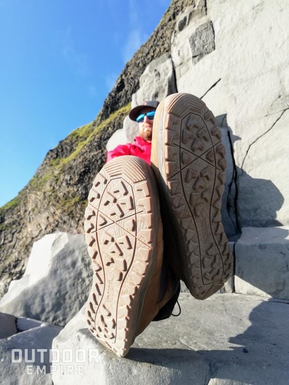 盘腿坐在岩石上，露出科迪亚克斯科根靴子的底部