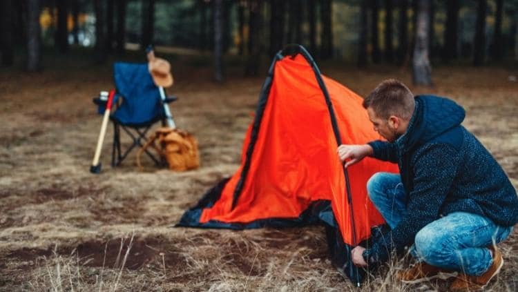 男子在营地搭帐篷